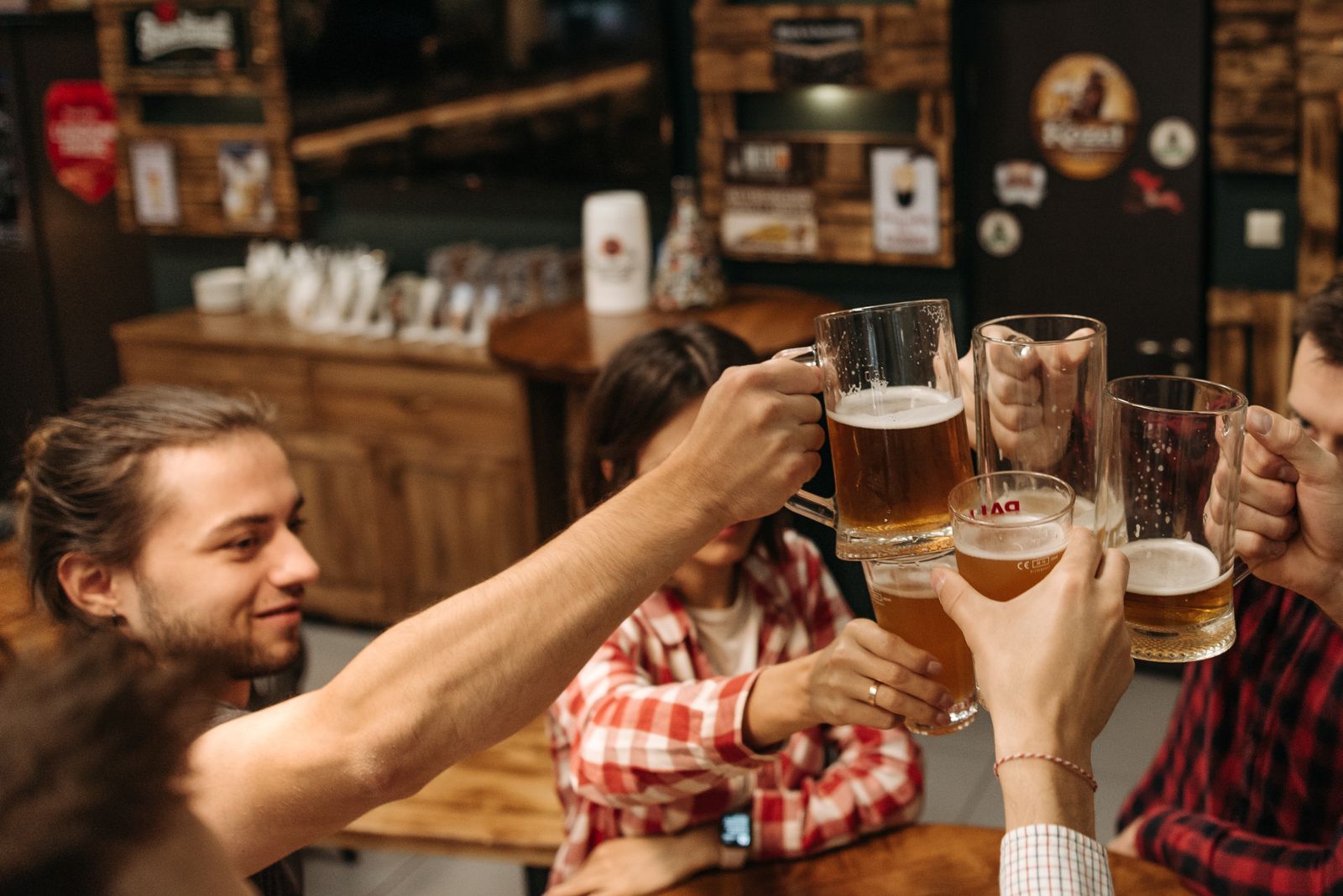 Friends toasting drinks at a lively bar