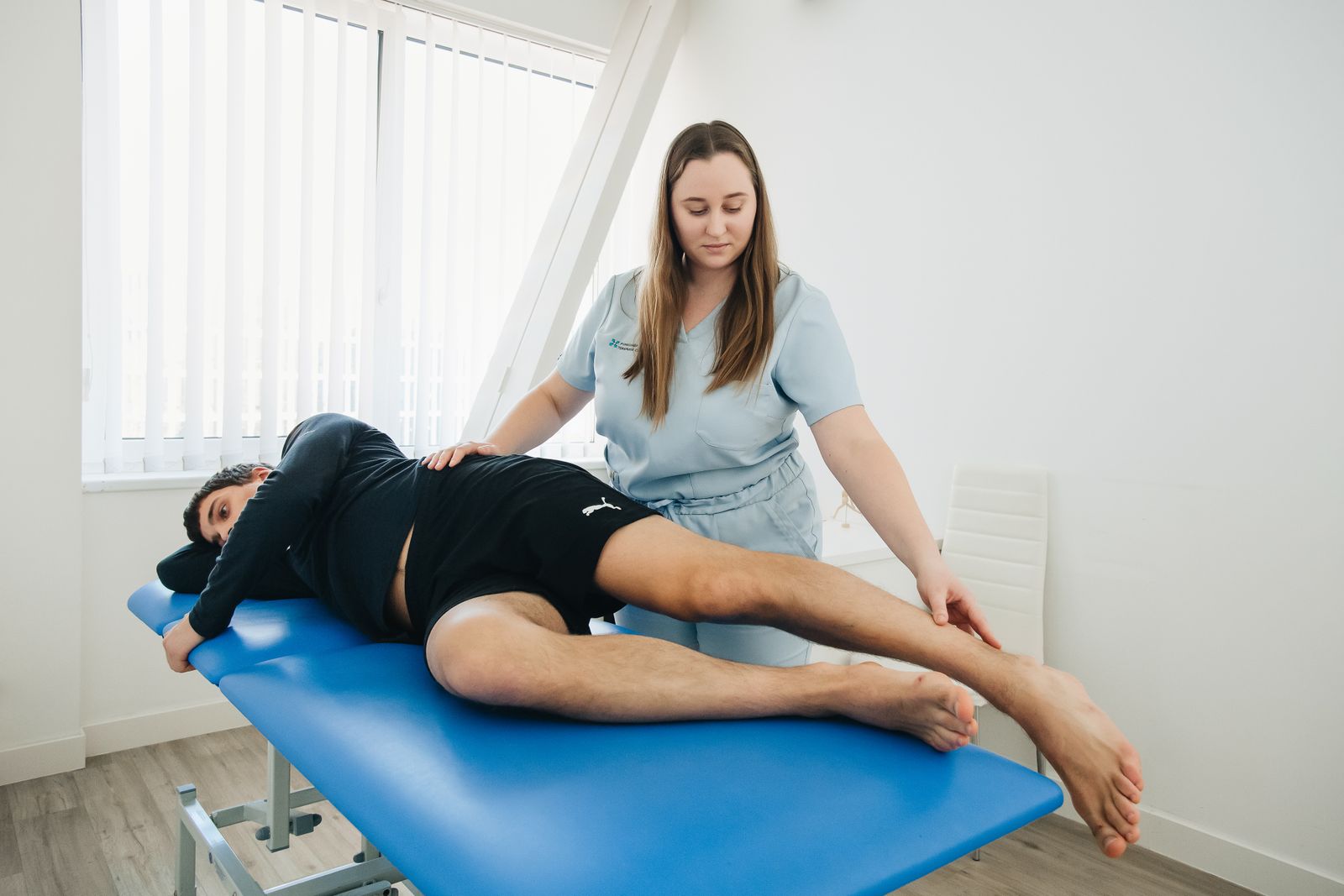 A physiotherapist assisting a patient in a rehabilitation session