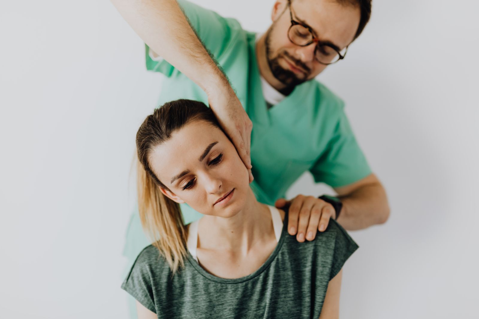 A chiropractor performing a neck adjustment