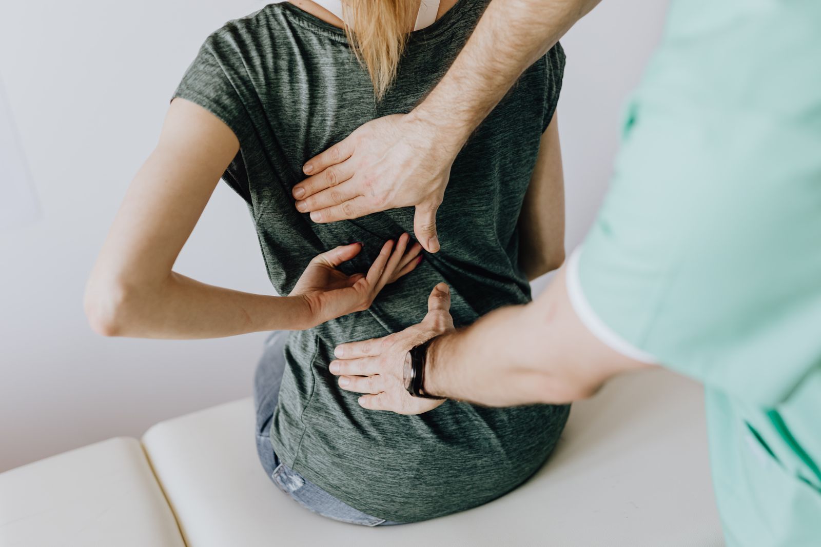 A patient receiving spinal care on an examination table