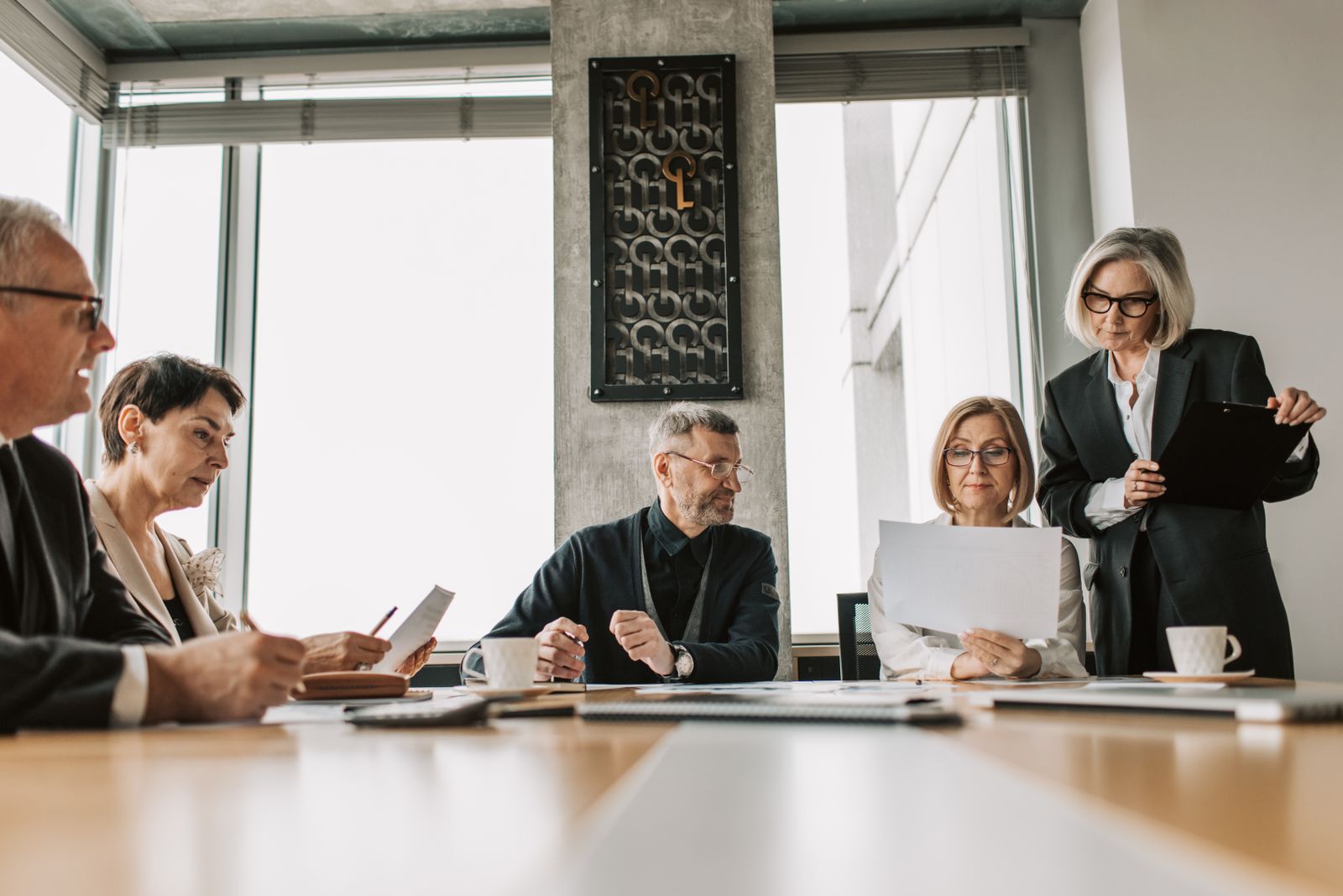 Business professionals discussing documents in a boardroom