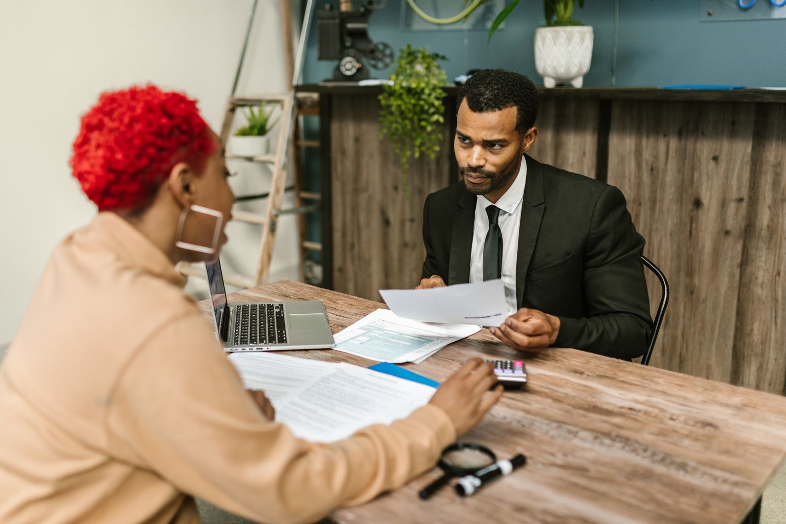Two professionals discussing financial documents