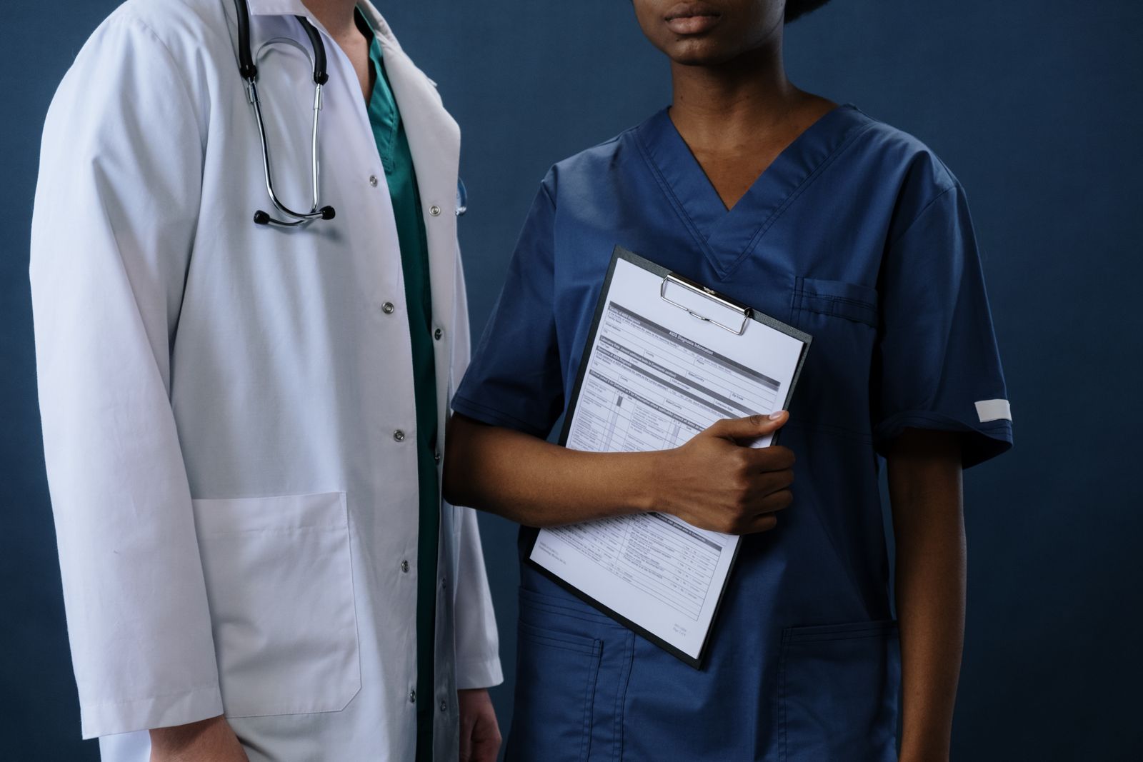 Healthcare professionals in scrubs and lab coats