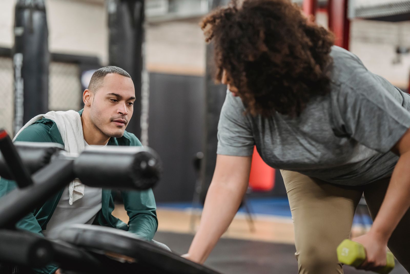 An instructor coaching a client through a workout