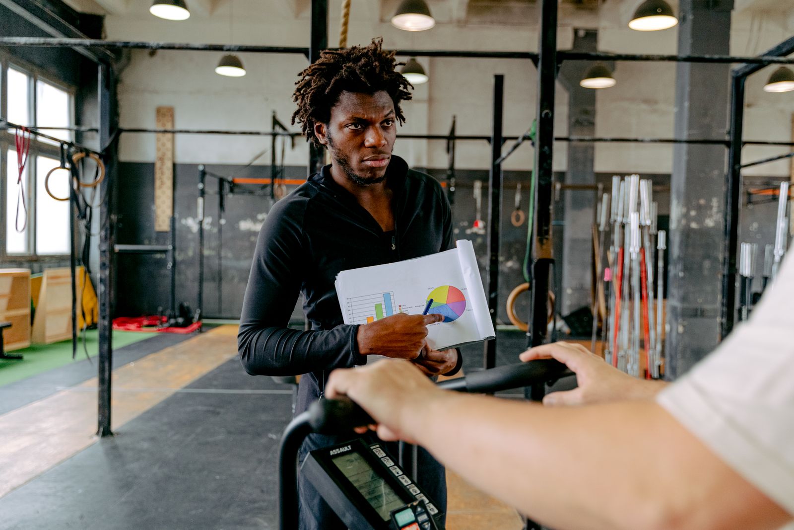 A personal trainer guiding a client through a workout