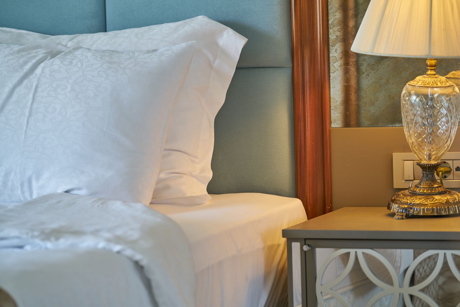 An elegant hotel bedroom with white linens