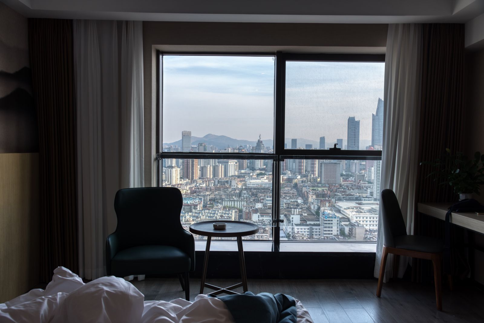 A hotel room with a city skyline view