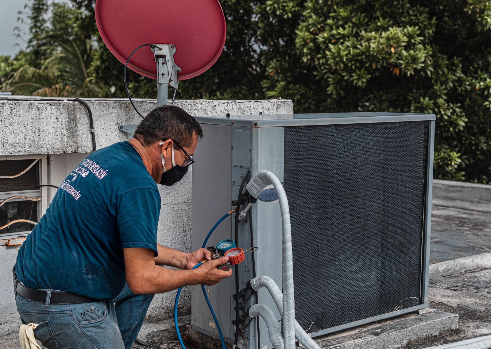 An HVAC technician servicing an air conditioner