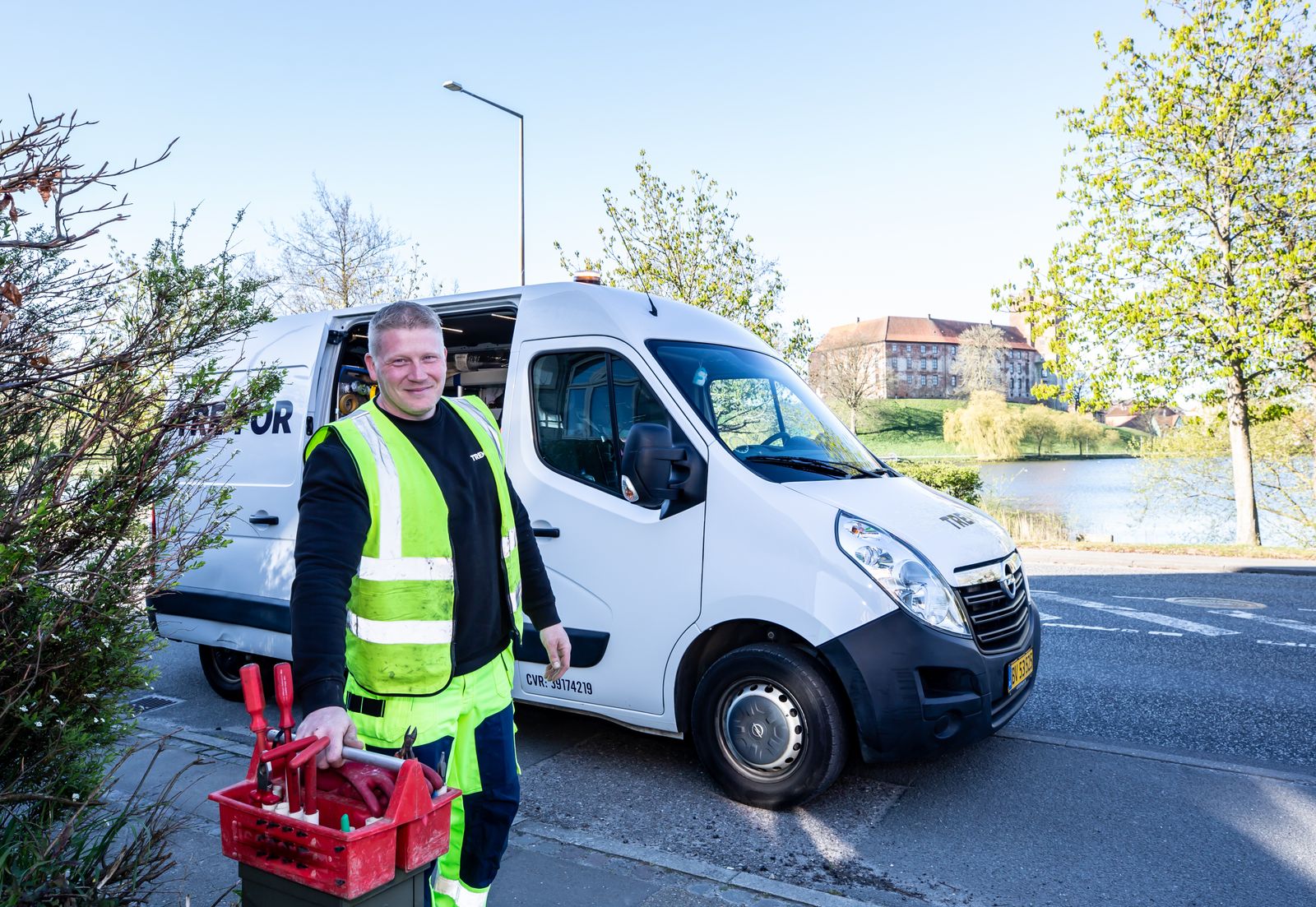 A plumber by a service van with tools