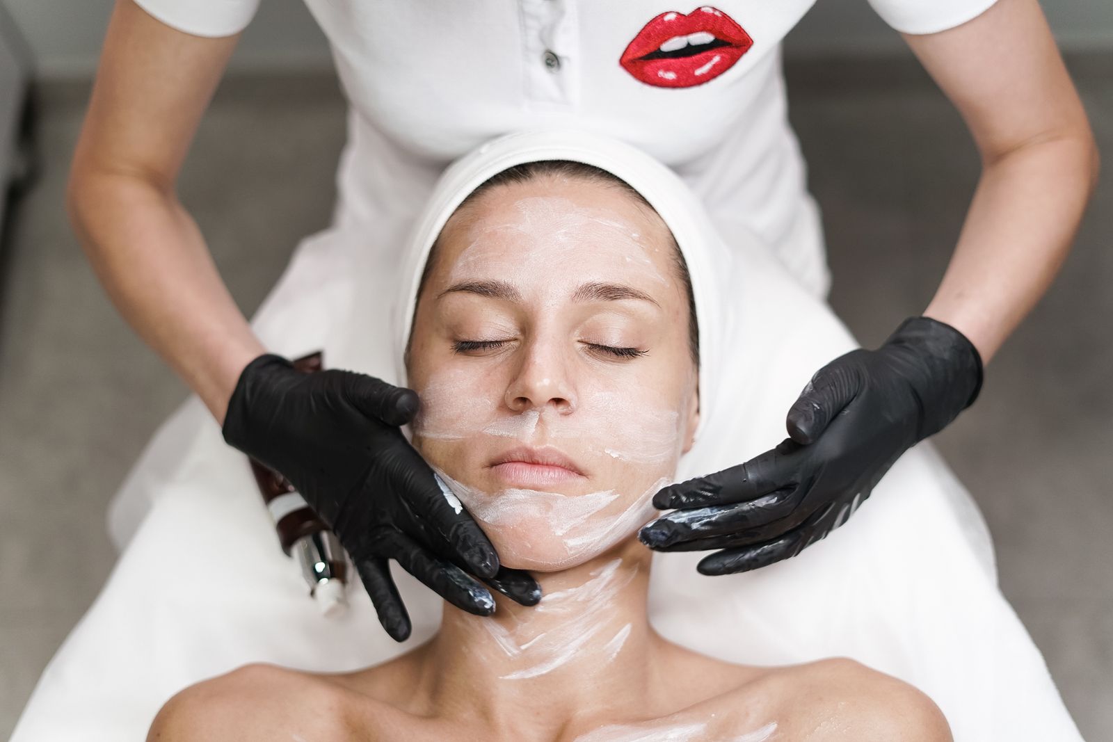 A woman receiving a facial treatment