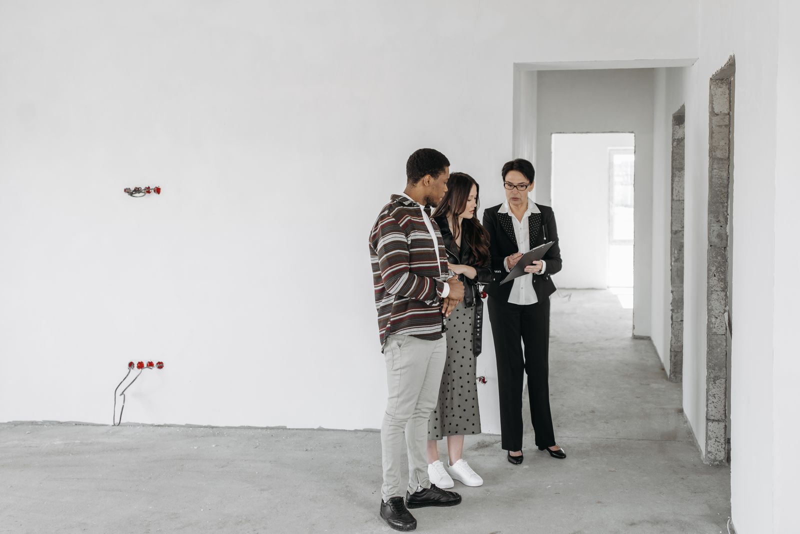 A real estate agent showing a property to a couple