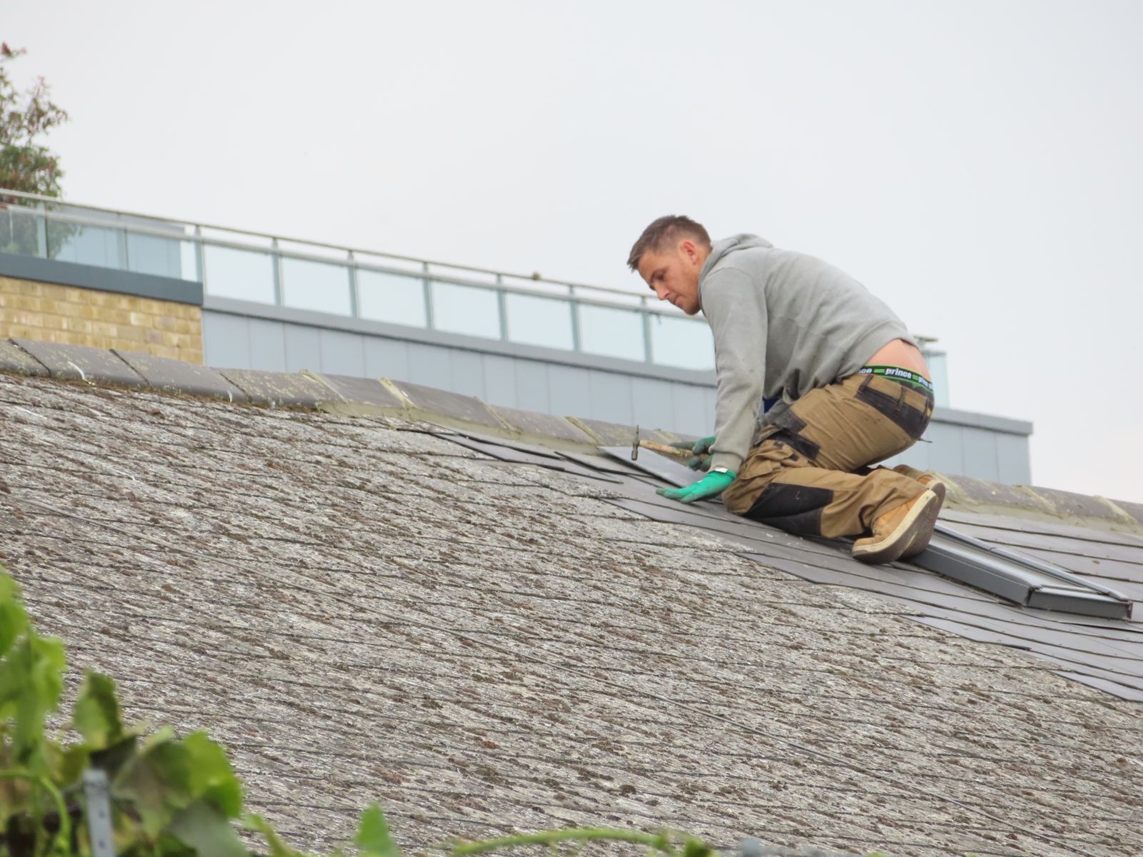 A roofer repairing a roof