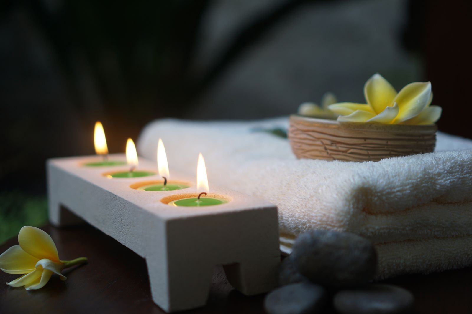 A relaxing spa scene with candles and soft towels