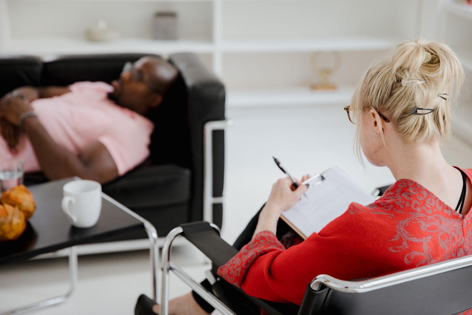 A therapist taking notes during a session